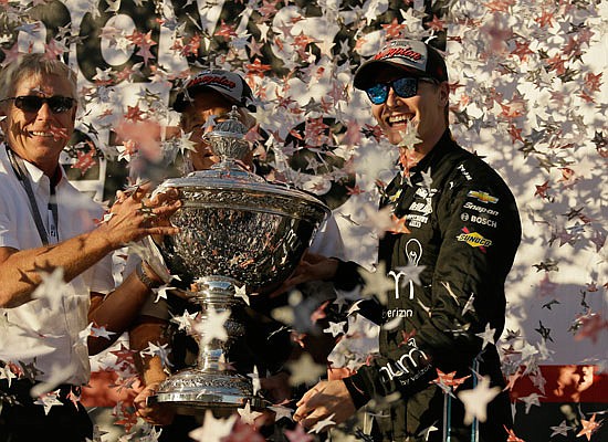 Josef Newgarden (right) celebrates Sunday after being presented the Astor Cup for winning the IndyCar championship in Sonoma, Calif.