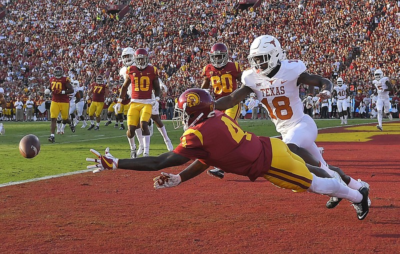 Southern California wide receiver Steven Mitchell Jr. left, can't reach a pass intended for him while under pressure from Texas defensive back Davante Davis during the first half of an NCAA college football game, Saturday, Sept. 16, 2017, in Los Angeles. 