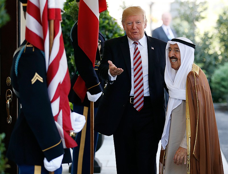 In this Thursday, Sept. 7, 2017 file photo, President Donald Trump, center, gestures as he greets the Amir of Kuwait Sheikh Sabah Al Ahmad Al Sabah as he arrives at the White House in Washington. Kuwait says it will expel North Korea's ambassador and four other diplomats from its embassy in Kuwait City. 