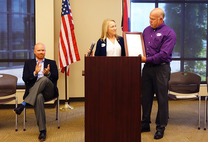 <p>Helen Wilbers/FULTON SUN</p><p>State Sen. Jeannie Riddle presents a declaration from Gov. Eric Greitens to Presiding County Commissioner Gary Jungermann, recognizing Callaway County’s status as a work-ready county. State Rep. Travis Fitzwater, left, also spoke.</p>