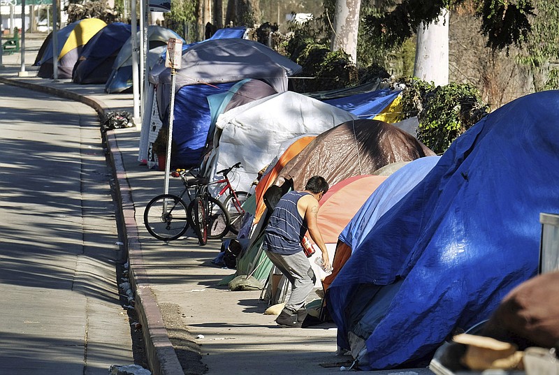FILE - This Tuesday, Jan. 26, 2016 file photo shows a homeless encampment on a street in downtown Los Angeles. Public health authorities on Tuesday, Sept. 19, 2017, declared an outbreak of the highly contagious liver disease hepatitis A in Los Angeles County, the third California region to see significant infections this year. Health officials reported the outbreak to the county Board of Supervisors, which requested a briefing due to the proximity of LA to San Diego, which has had more than 420 cases and more than a dozen deaths since early this year. (AP Photo/Richard Vogel, File)