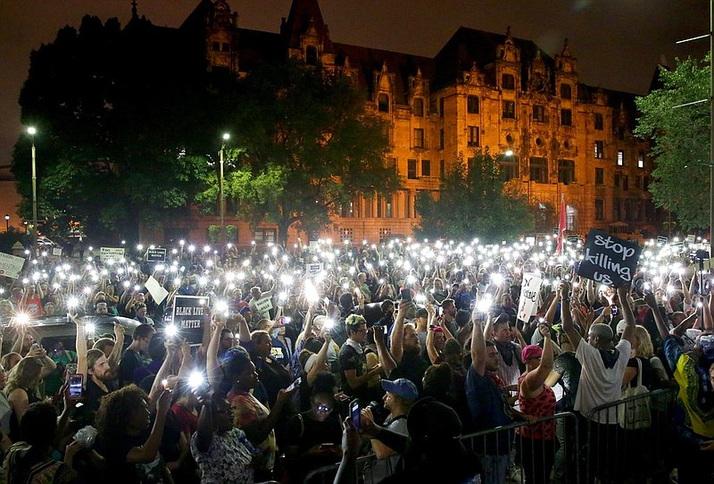 Protesters stand outside of the St. Louis city jail on Monday, Sept. 18, 2017. The protesters chanted "free our people" outside the jail on Monday night to show solidarity with those who remain behind bars. Police said that more than 120 people were arrested during Sunday's protests. Monday was the fourth day of protests over the acquittal of a white former police officer in the killing of a black suspect. (David Carson/St. Louis Post-Dispatch via AP)