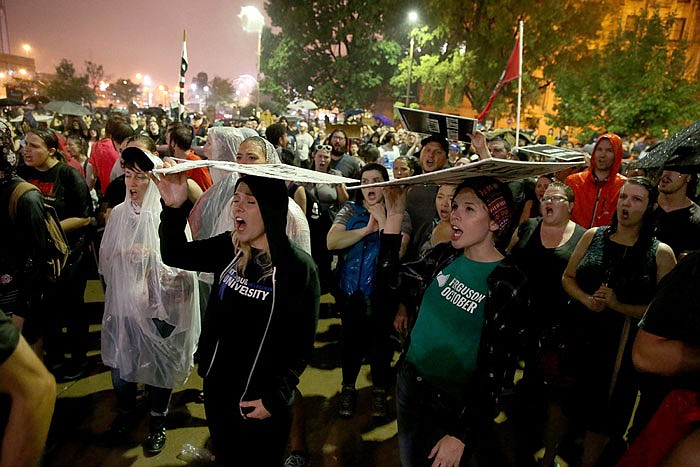 Hundreds of protesters stand in the rain outside of the St. Louis city jail on Monday.