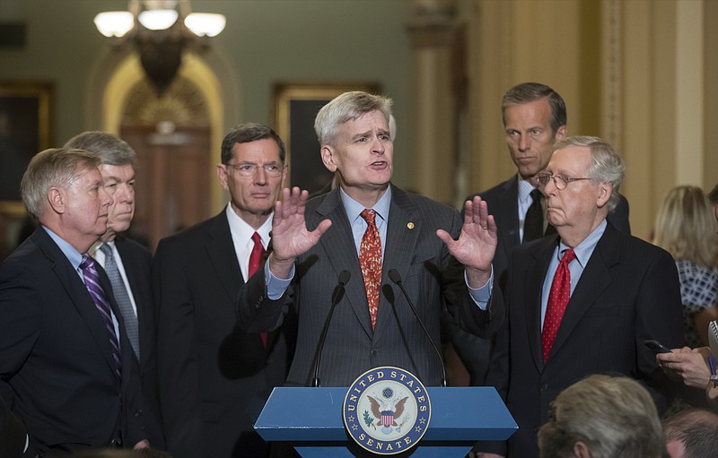 Sen. Bill Cassidy, R-La., center, joined by, from left, Sen. Lindsey Graham, R-S.C., Sen. Roy Blunt, R-Mo., Sen. John Barrasso, R-Wyo., Sen. John Thune, R-S.D., and Senate Majority Leader Mitch McConnell, R-Ky., speaks to reporters as he pushes a last-ditch effort to uproot former President Barack Obama's health care law, at the Capitol in Washington, Tuesday, Sept. 19, 2017. (AP Photo/J. Scott Applewhite)