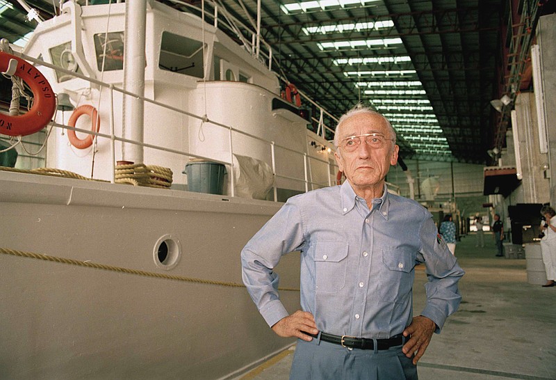 FILE - In this July 14, 1986 file photo, marine explorer Captain Jacques Cousteau is seen with his newly-refurbished Calypso in Miami, Fla.. A fire on marine explorer Jacques Cousteau's iconic ship, Calypso, has delayed the vessel's restoration by between six to eight months, the Cousteau Society said Wednesday, Sept. 20, 2017. The fire only damaged the ship's newly fitted portions, and the damage will not derail the restoration of the ship, which was due to be completed in early 2019. (AP Photo/Kathy Willens, file)