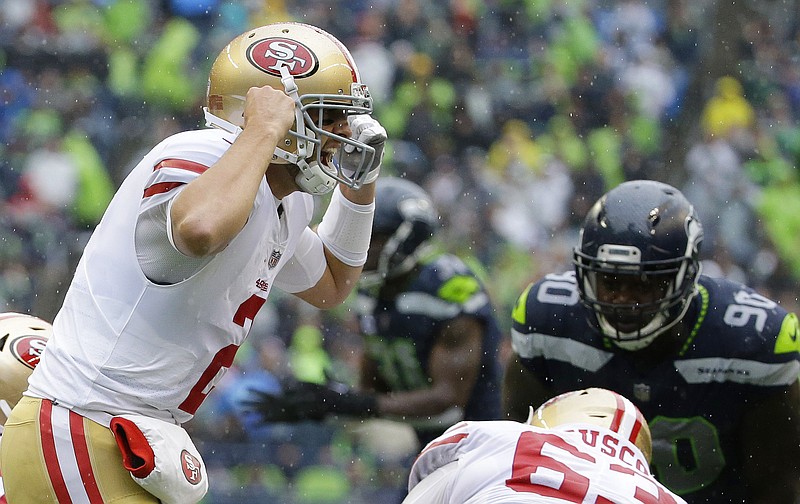 San Francisco 49ers quarterback Brian Hoyer, left, yells on the line of scrimmage in the second half of an NFL football game against the Seattle Seahawks, Sunday, Sept. 17, 2017, in Seattle. 