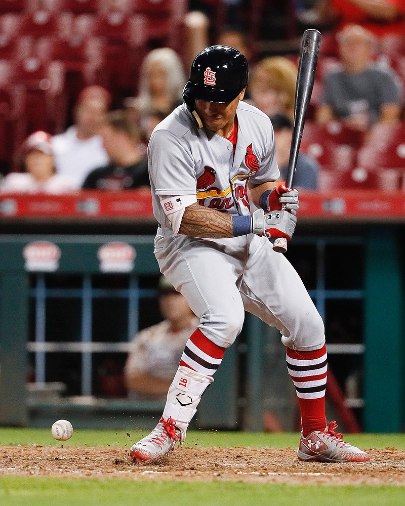 St. Louis Cardinals' Kolten Wong is hit by a pitch from Cincinnati Reds relief pitcher Tim Adleman in the tenth inning of a baseball game, Tuesday, Sept. 19, 2017, in Cincinnati. The Cardinals won 8-7. 