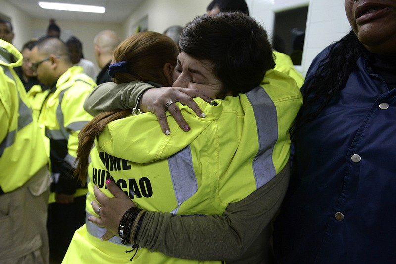 Rescue team members Candida Lozada, left, and Stephanie Rivera, right, embrace Wednesday, Sept. 20, 2017, in Humacao, Puerto Rico, as they wait to assist in the aftermath of Hurricane Maria.