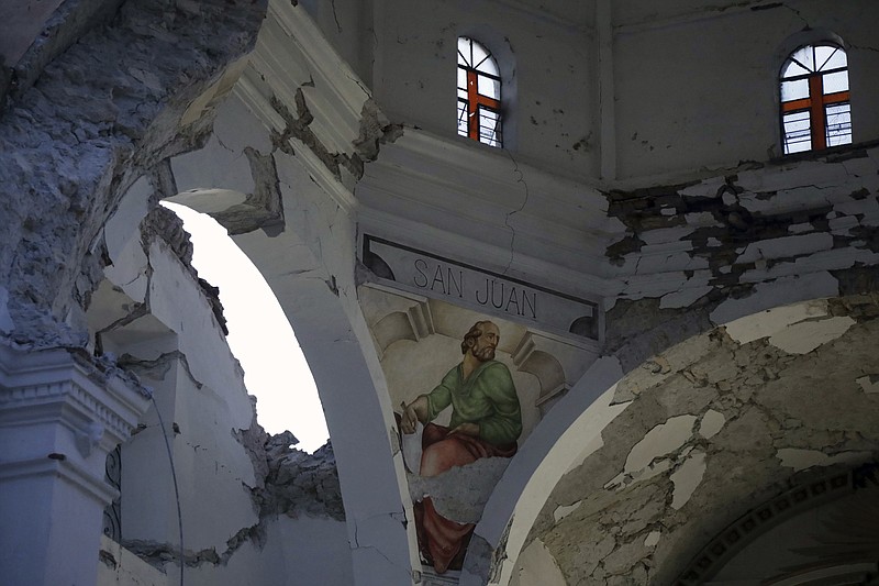 The Santiago Apostol church stands damaged after the 7.1 earthquake Wednesday Sept. 20, 2017, in the town of Atzala in Puebla state, Mexico. According to family members of the 11 people who died inside the church during Tuesday's quake, the roof collapsed during a Mass held to baptize a two-year-old girl, and the only people who survived were the baby's father, the priest and the priest's assistant.