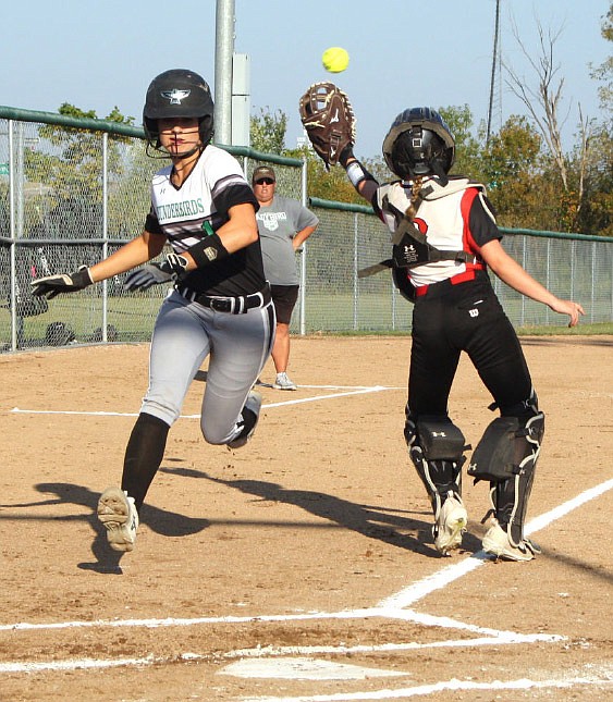 North Callaway senior shortstop Kallie Jo Lehenbauer dodges Community R-6 freshman catcher
Emmi Johnson at home plate during Tuesday night's EMO game in Auxvasse, Mo. Lehenbauer scored
on senior first baseman Hanna Knipp's two-run single in the bottom of the first inning as the Ladybirds dismantled the Lady Trojans in the decisive 10-0 victory.