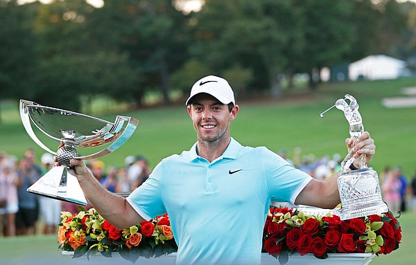 In this Sept. 25, 2016, file photo, Rory McIlroy poses with the trophies after winning the Tour Championship and the FedEx Cup at East Lake Golf Club in Atlanta.