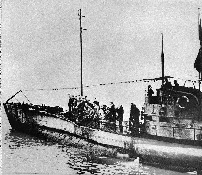 In this undated photo people stand on the deck of a World War I German submarine type UC-97 in an unknown location. Belgian regional authorities on Tuesday, Sept. 19, 2017 say that an intact German World War I submarine has been found off the coast of Belgium.