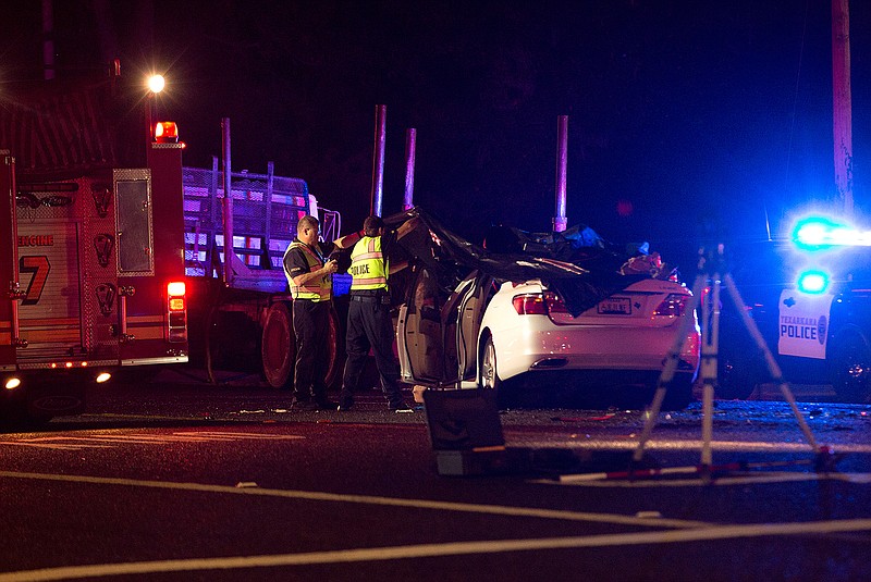 Crime scene investigators collect evidence at a fatal crash Wednesday night on Lake Drive in Texarkana, Texas.