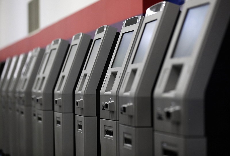 In this Wednesday, Aug. 30, 2017, photo, automated teller machines are lined up during the manufacturing process at Diebold Nixdorf in Greensboro, N.C. With the exception of the vending machine, no piece of technology has done more to create the culture of "self-service" than the ATM. 2017 marks the 50th anniversary of the ATM. (AP Photo/Gerry Broome)
