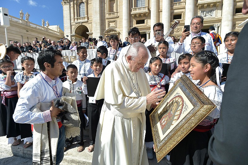Pope Francis meets members of a children's choir from Mexico during his weekly general audience, in St. Peter's Square, at the Vatican, Wednesday, Sept. 20, 2017. The pontiff prayed for the victims of the 7.1 magnitude quake that hit Mexico on Tuesday leaving several hundred dead, including children trapped under a collapsed school in Mexico City. (L'osservatore Romano/Pool Photo via AP)