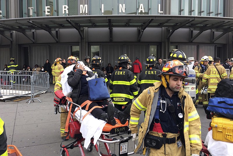 FILE - In this Jan. 4, 2017 file photo, an injured passenger is taken from the Atlantic Terminal in the Brooklyn borough of New York after a Long Island Rail Road train hit a bumping block. Federal investigators have found that the engineers of two New York City-area commuter trains that crashed into stations were both suffering from severe sleep apnea. The National Transportation Safety Board said Thursday, Sept. 21, 2017,  the similar circumstances of the crashes warranted combining findings and recommendations into a single special report. (AP Photo/Mark Lennihan)