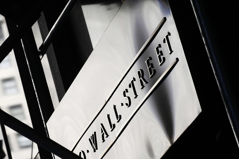 FILE - This July 15, 2013, file photo, shows a sign for Wall Street outside the New York Stock Exchange. U.S. stock indexes veered slightly lower in early trading Thursday, Sept. 21, 2017, as investors sized up the latest batch of company earnings and deal news. (AP Photo/Mark Lennihan, File)