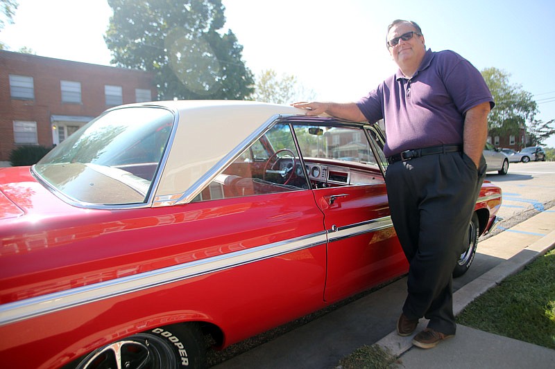 Gary Waggoner poses for a portrait Tuesday, Sept. 19, 2017 with his 1964 Plymouth Fury at the corner of West Dunklin and Broadway in Jefferson City. Dozens of cars will line Dunklin Street during the 48th annual Mid-Mo Old Car Club Round Up and Show on Sept. 30.