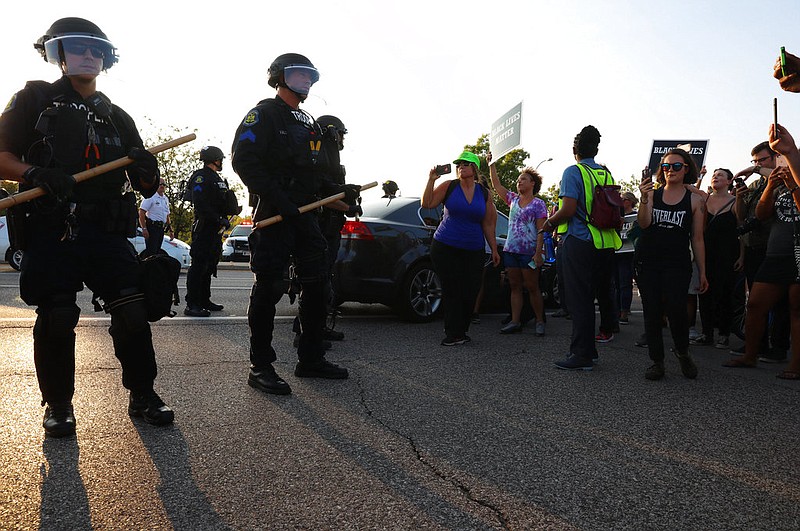 St. Louis County police say they broke up a demonstration near an upscale mall because protesters weren't listening to instructions and tried to evade two lines of officers blocking the on-ramp to a highway, Wednesday, Sept. 20, 2017, in St. Louis. Protests have taken place since Friday's acquittal of a white former St. Louis police officer for the fatal shooting of black drug suspect. (Christian Gooden/St. Louis Post-Dispatch via AP)