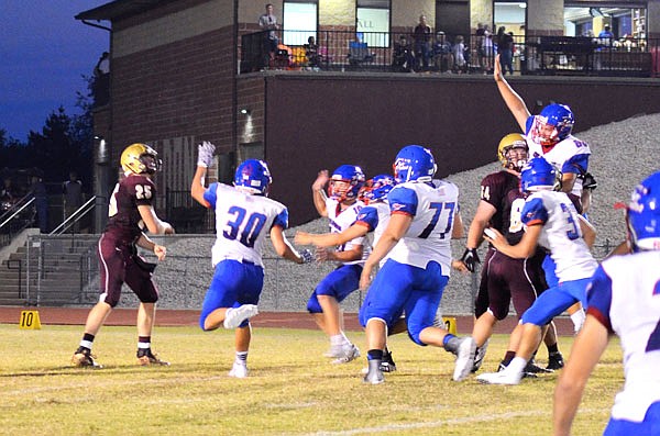 Eldon quarterback Dawson Brandt (far left) throws a pass ahead of the rush of California's Jacob Adams (30) and other players on the Pintos' defense during last Friday's game in Eldon.