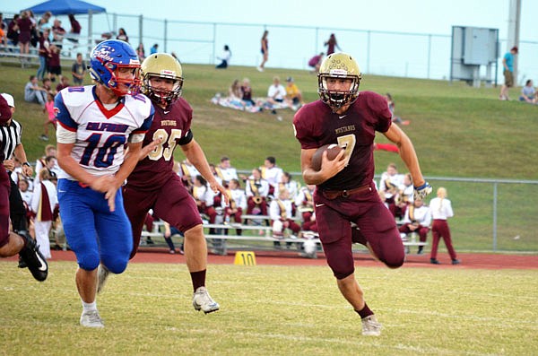 Trenton Dillon of Eldon carries the ball for a first down during last Friday night's game against California.