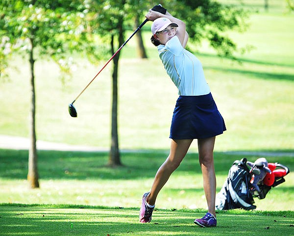 Alex Nelson of Helias watches her tee shoot on the 11th hole during the Capital City Invitational on Wednesday at Meadow Lake Acres Country Club.