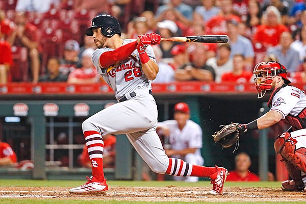 Tommy Pham of the Cardinals hits an RBI double in the third inning of Wednesday night's game in Cincinnati.