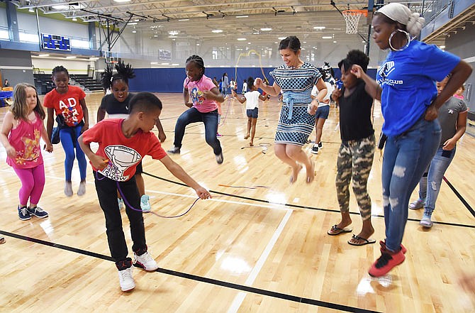 Mayor Carrie Tergin, center, joined staff and students from Boys & Girls Club of Jefferson City on Wednesday jumping rope after representatives of UnitedHealthcare donated NERF Energy Game kits to the club at The Linc. The kit contains a fitness tracking band, which tracks exercise and accumulates "energy points" to purchase activities within the app.