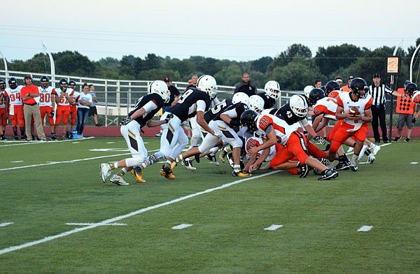 The Versailles defense, shown here competing against Knob Noster earlier this season, expects a tough test from the School of the Osage offense tonight.