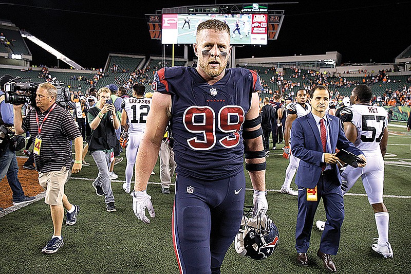 In this Thursday, Sept. 14, 2017, file photo, Houston Texans defensive end J.J. Watt (99) walks off the field after the team's 13-9 win over the Cincinnati Bengals in an NFL football game in Cincinnati. Watt has recovered from the back surgery which cost him 13 games last season. Now Houston's star defensive end is dealing with a painful finger injury as he looks for his first sack this year and the Texans prepare for the New England Patriots.  