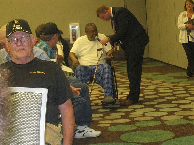 Zachary M. Sage, associate director for the U.S. Department of Veterans Affairs' Overton Brooks VA Medical Center in Shreveport, La., takes local military veterans' comments during a VA town hall meeting Thursday evening at the Arkansas Convention Center. The next local meeting is tentatively set for early next year.
