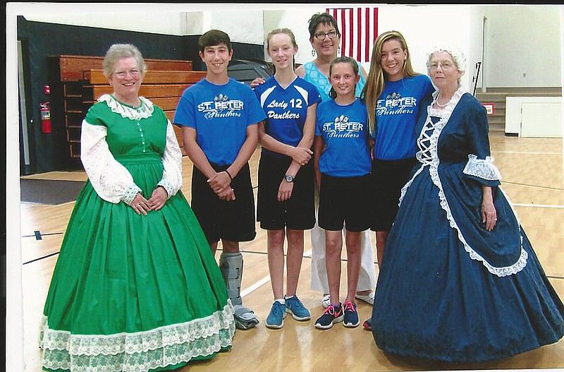 Members of the Daughters of the American Revolution on Thursday celebrated Constitution Week at St. Peter's School in Fulton. From left, including students, are: Nelta Cherry (as Abigail Adams), Ashton Pezold, Lydia Backer, Deb Jacobsen, Olivia Moberly, Sabrina Schlacks and Betty McAtee (as Martha Washington). (Submitted photo)