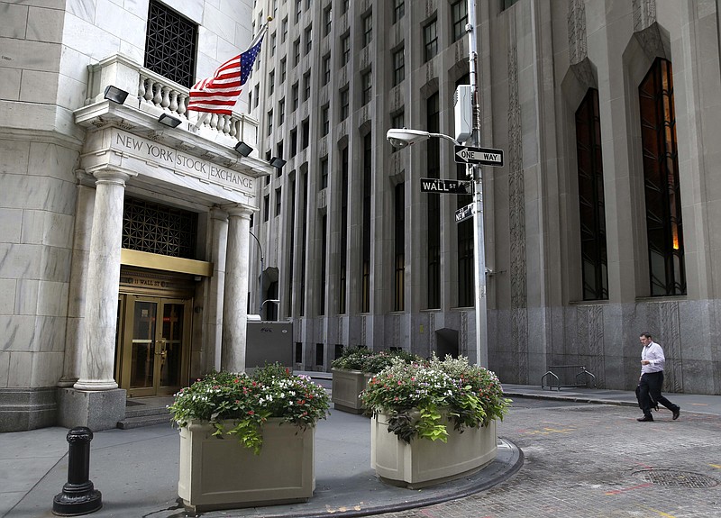 FILE - In this Monday, Aug. 24, 2015, file photo, a man walks towards the New York Stock Exchange. Stocks are opening slightly lower on Wall Street, Friday, Sept. 22, 2017, as technology companies and banks decline. (AP Photo/Seth Wenig, File)