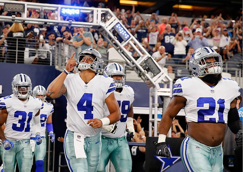 In this Aug. 26, 2017, file photo, Dallas Cowboys' Dak Prescott (4) and Ezekiel Elliott (21) lead the team onto the field for a preseason NFL football game against the Oakland Raiders in Arlington, Texas. Prescott and Elliott never really had a humbling "welcome to the NFL" moment together as rookies. It finally came in their 18th game. The question now is how the star Cowboys respond. 
