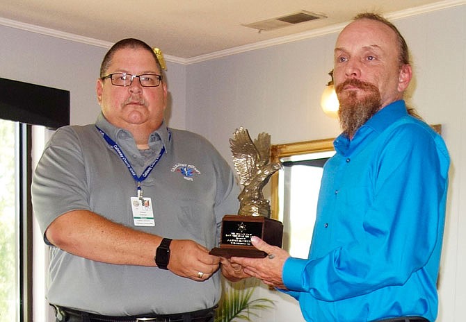Charles Anderson, left, director of Callway County Ambulance District, presented investigator Aaron Hazelton with the G.W. Law Award at the Wednesday Fulton Rotary Club meeting.