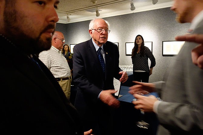 U.S. Sen. Bernie Sanders, I-Vt., who spoke about foreign policy Thursday at Westminster College, reaches out to shake a hand at a private reception at the National Churchill Museum.