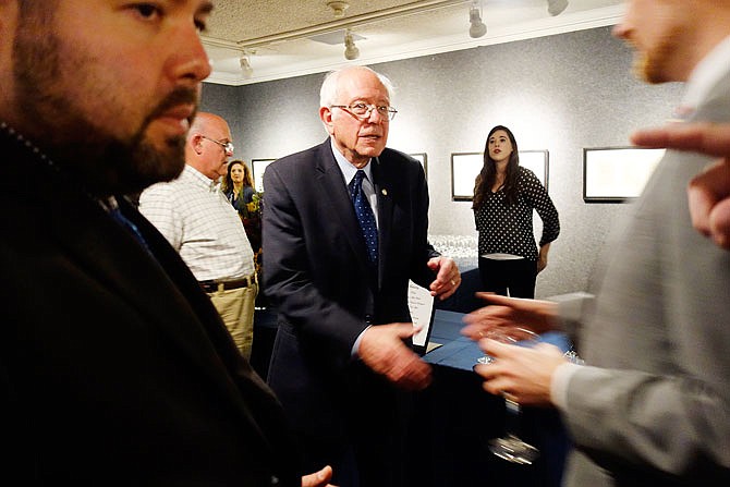 U.S. Sen. Bernie Sanders, of Vermont, who spoke about foreign policy at Westminster College's Green Lecture on Thursday, reaches out to shake a hand at a private reception at the National Churchill Museum.