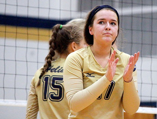 Jada Oldham of Helias applauds the play of her team after getting a point during Thursday night's match against the Rock Bridge Bruins at Rackers Fieldhouse.