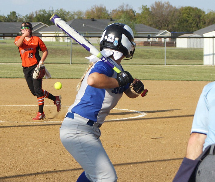 New Bloomfield freshman starter Sarah Abbott follows through on a pitch to South Callaway freshman catcher Andrea Witt in the first inning of Thursday night's Show-Me Conference matchup in New Bloomfield. Abbott struck out eight and also hit a grand slam to spark the Lady Wildcats' 10-4 victory over the Lady Bulldogs.