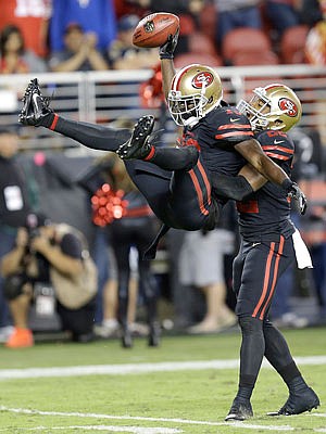 Aldrick Robinson celebrates with 49ers teammate Matt Breida after recovering a fumble during the second half of Thursday's game against the Rams in Santa Clara, Calif.