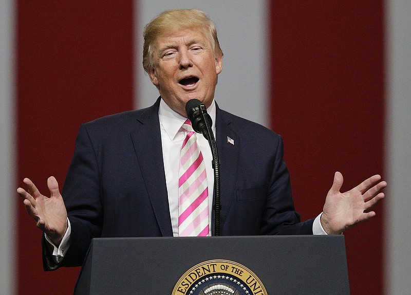 In this Sept. 22, 2017, photo President Donald Trump speaks at a campaign rally in Huntsville, Ala.  Trump says he wants to lure Democratic lawmakers to sign on to a Republican-crafted tax overhaul plan. But negotiators must grapple with the reality that any handouts to Democrats quickly could turn into turn-offs for the GOP. (AP Photo/Brynn Anderson)