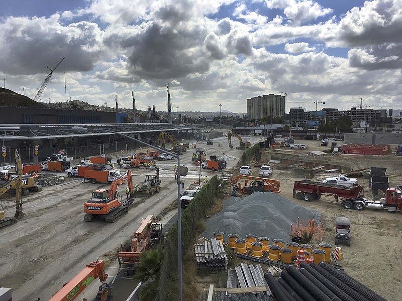 Heavy machinery and construction crews work on the first day of a 57-hour closure of all Mexico-bound car traffic at the San Ysidro border crossing, where about 50,000 cars and 20,000 pedestrians go back and forth every day in San Diego, Calif., on Saturday, Sept. 23, 2017. Once complete in 2019, there will be 10 southbound lanes, twice the current number, and eight more lanes from Mexico to the United States. (AP Photo/Elliot Spagat)