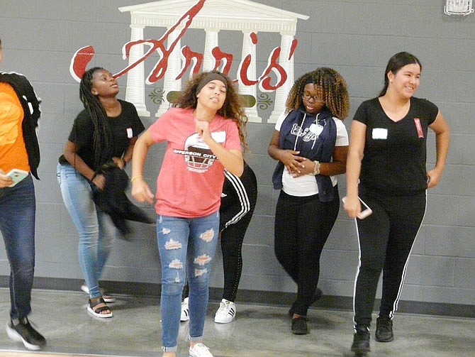 Students from Thomas Jefferson Middle School, who were attending a Council for Drug Free Youth event at The Linc wellness center, cavort in front of the new logo on the gym wall, recognizing the gym's renaming in honor of Arris Pardolos.
