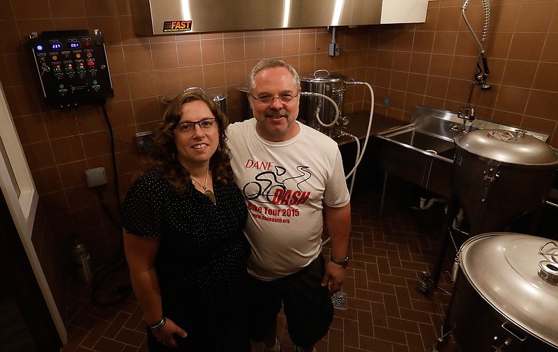 In this Sept. 15, 2017 photo Steve Clemens and daughter Jillian Clemens pose for a picture in their home basement brewery in Lodi, Wis. For many home brewers, having a dedicated space for brewing is both practical and fun and creating such a space requires some creativity. 