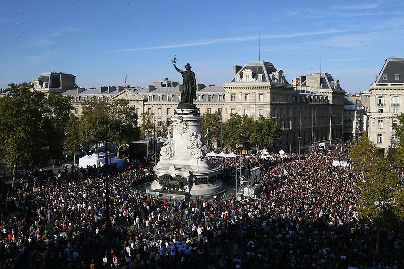Supporters of French far-left leader Jean-Luc Melenchon are gathered on Republique square to listen their leader Saturday, Sept. 23, 2017, during a protest over the president's labor reform in Paris, France. 