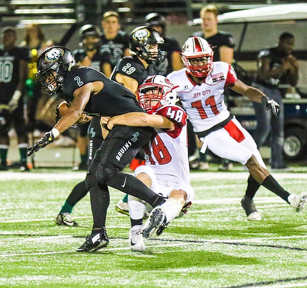 Jefferson City linebacker Carson Berendzen tackles Rock Bridge running back Nate Peat during Friday night's game in Columbia.