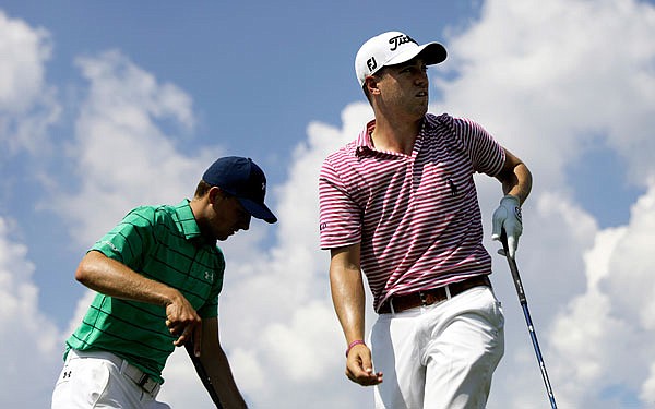 Justin Thomas (right) watches his shot after teeing off on the sixth hole as Jordan Spieth steps up to hit during the second round of the Tour Championship golf tournament Friday at East Lake Golf Club in Atlanta.