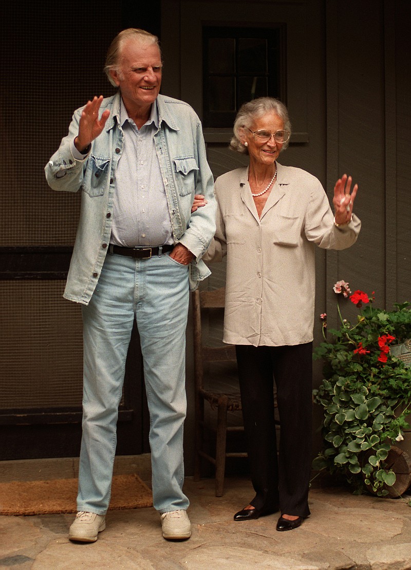 The Rev. Billy Graham and his wife Ruth wave goodbye to the media following a 1996 press conference at their home in Montreat.