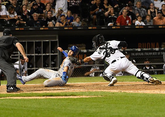 White Sox catcher Omar Narvaez tags out Whit Merrifield of the Royals at home during the ninth inning of Friday night's game in Chicago.