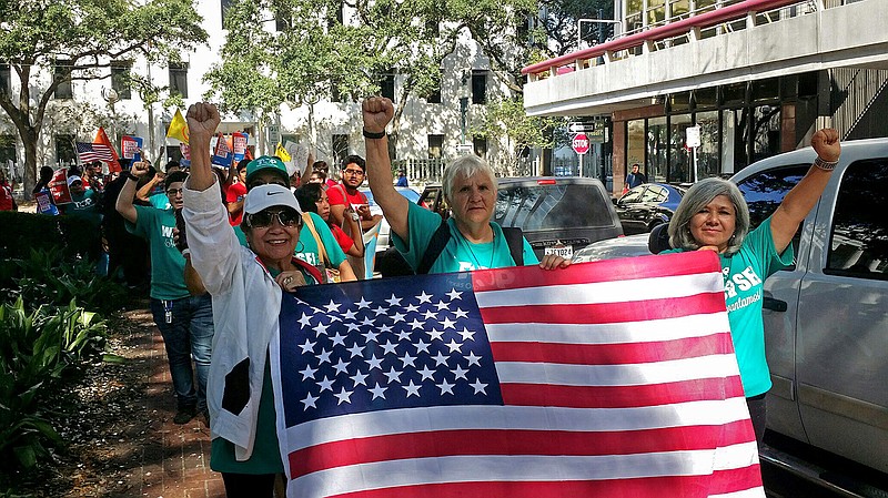 Demonstrators march outside federal court in New Orleans, Friday, Sept. 22, 2017. With immigrants and their advocates chanting and beating drums outside, a federal appeals court heard arguments Friday on whether it should allow a Texas law aimed at combatting "sanctuary cities" to immediately take effect. 